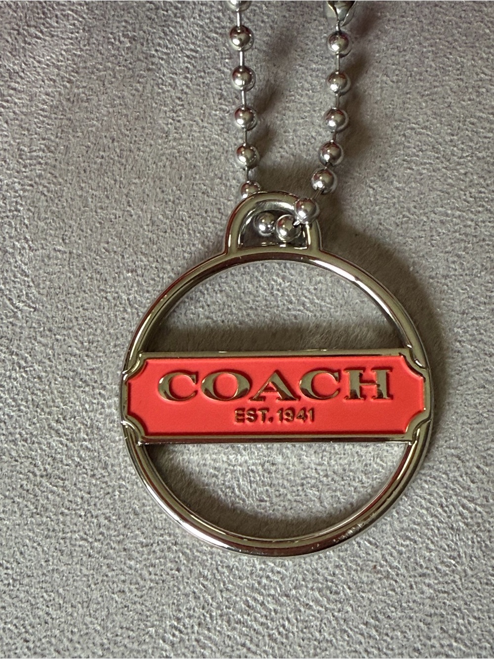 Coach Silver-Tone Circle Pendant with Coral Enamel Logo hang tag